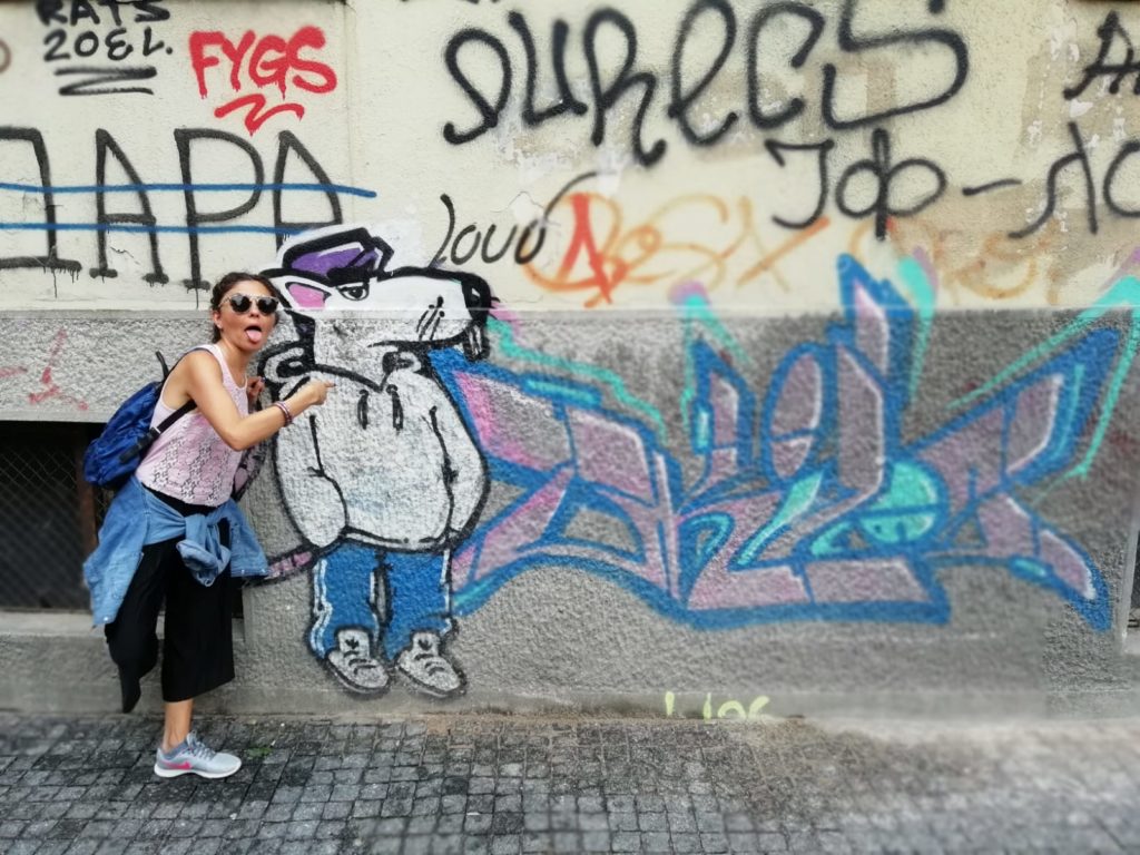 Duvara çizilmiş fare grafitisi ile beraber dilini dışarıya çıkarıp Belgrad'da ne yenir ? yazısında poz veren gezginstar.